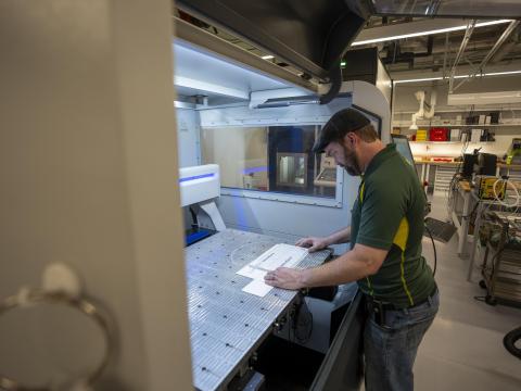 A person stands at a workbench in the Oregon Fabrication and Design facility.