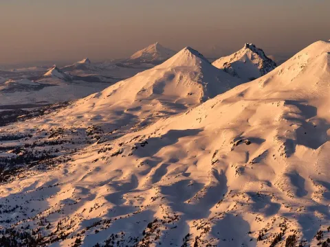 An aerial image of snow-capped mountains.